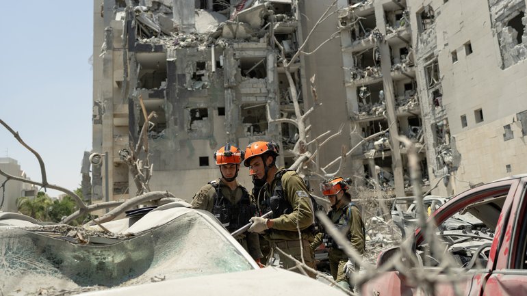 Emergency responders work at a building where four people were killed by an Iranian missile strike in Beersheba, Israel.