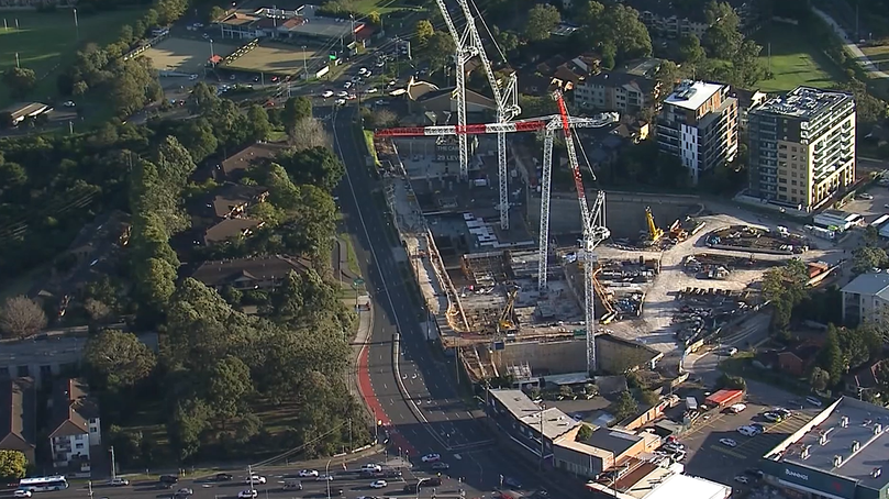 A crane was seen leaning precariously at a Meriton construction site.