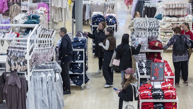 Shoppers surrounded by cheap fashion.