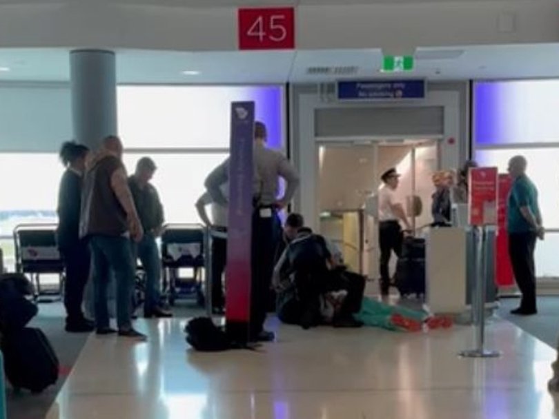 A man is wrestled to the ground in the Virgin terminal at Brisbane's domestic airport.