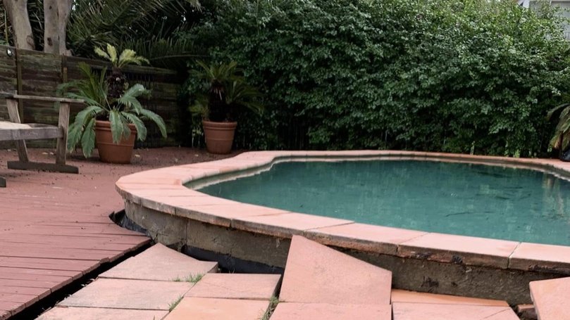 Tiles around the pool are noticably shifed into awkward angles due to the intensity of the landslide. Picture: Facebook ,