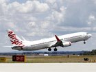 A Virgin Australia flight from Melbourne was delayed over an hour after a green tree snake was discovered, likely having hitched a ride from Queensland. (Con Chronis/AAP PHOTOS)