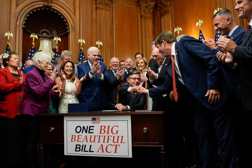 US House Speaker Mike Johnson, a Republican from Louisiana, center, shakes hands with House Republicans during an enrollment ceremony following a vote at the US Capitol in Washington, DC, US, on Thursday, July 3, 2025. President Donald Trump secured a sweeping shift in US domestic policy as the House passed a $3.4 trillion fiscal package that cuts taxes, curtails spending on safety-net programs and reversed much of Joe Biden's efforts to move the country toward a clean-energy economy. Photographer: Kent Nishimura/Bloomberg