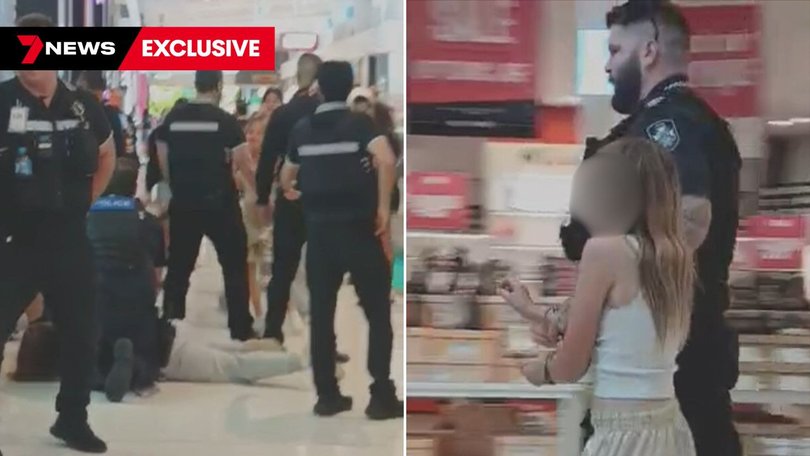 Officers detain a group of teens after the shopping centre brawl.