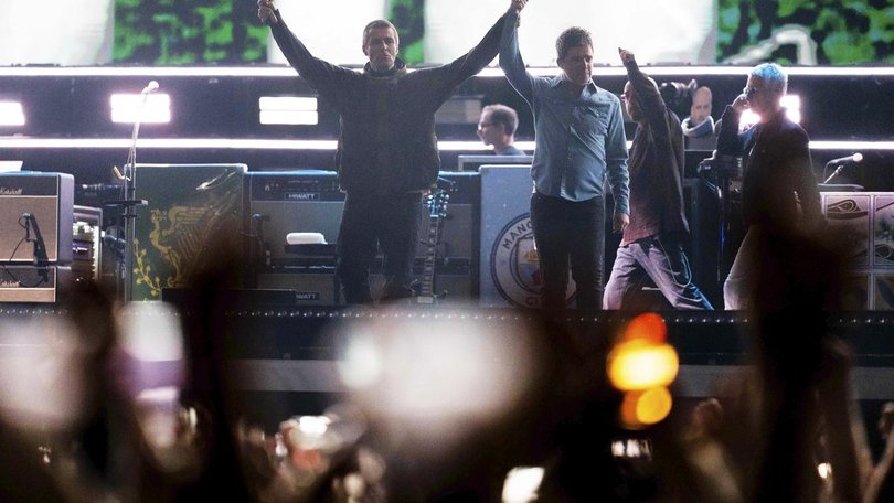 Liam and Noel Gallagher have opened their reunion tour with a concert in Cardiff, Wales. (AP PHOTO)