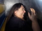 Patterson tries to shield her face from cameras.