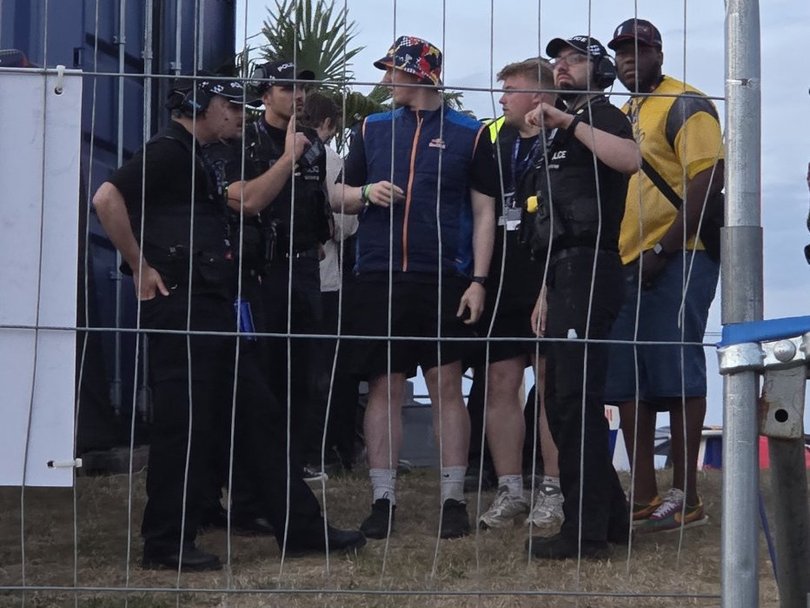 The TikTokker and his crew being detained by police at the F1 event.