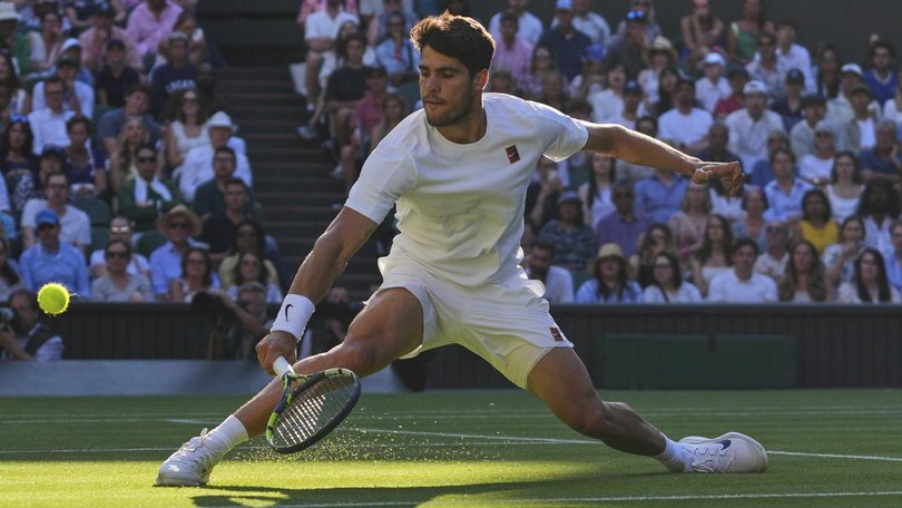 Spain's Carlos Alcaraz slides out of the shadows to return a shot in his win over Cameron Norrie. (AP PHOTO)
