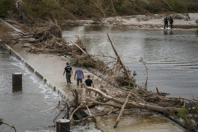 Response personnel attempted to recover a body in the Guadalupe River following catastrophic flooding in Kerrville, Texas.