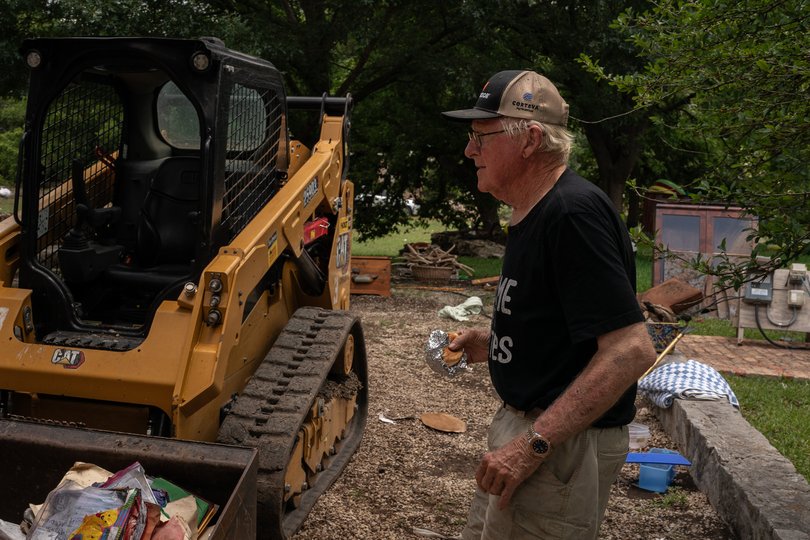 Tom Killian surveys recovery work at this home, along the Guadalupe River in Hunt, Texas.