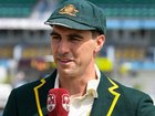 Pat Cummins wore his new baggy green (left) before reverting back to the old one (right). 