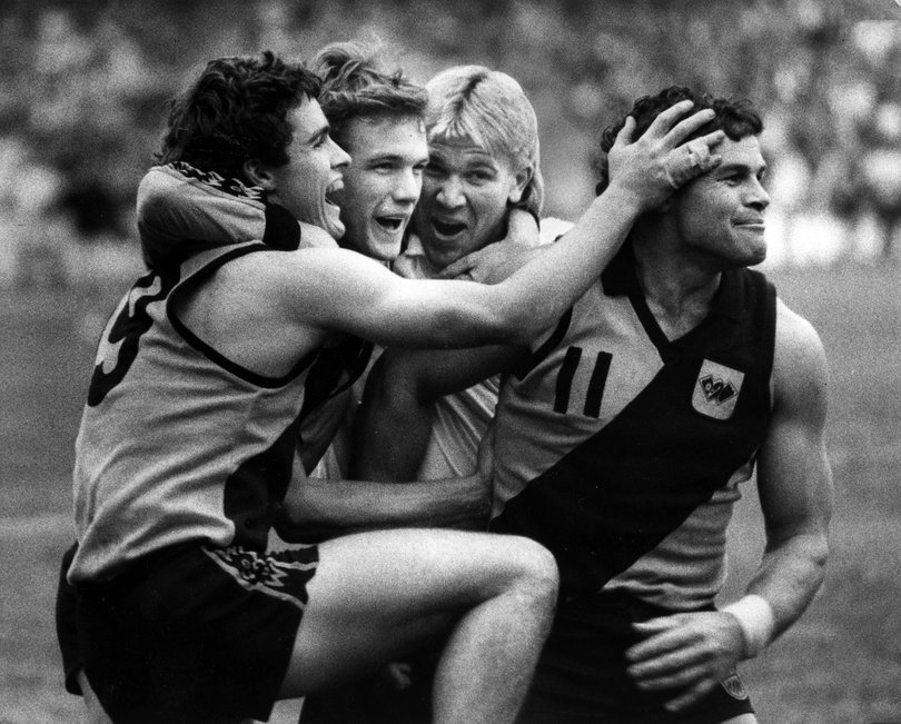  The new and the old: State team rookies (from left) Andrew MacNish, Dean Laidley and Chris Mainwaring (left out of the team at the last minute), share their joy with veteran skipper Brian Peake. 
(WA winners by 3 points). 