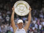 Poland's Iga Swiatek celebrates with the Wimbledon trophy after her ruthless win. (AP PHOTO)