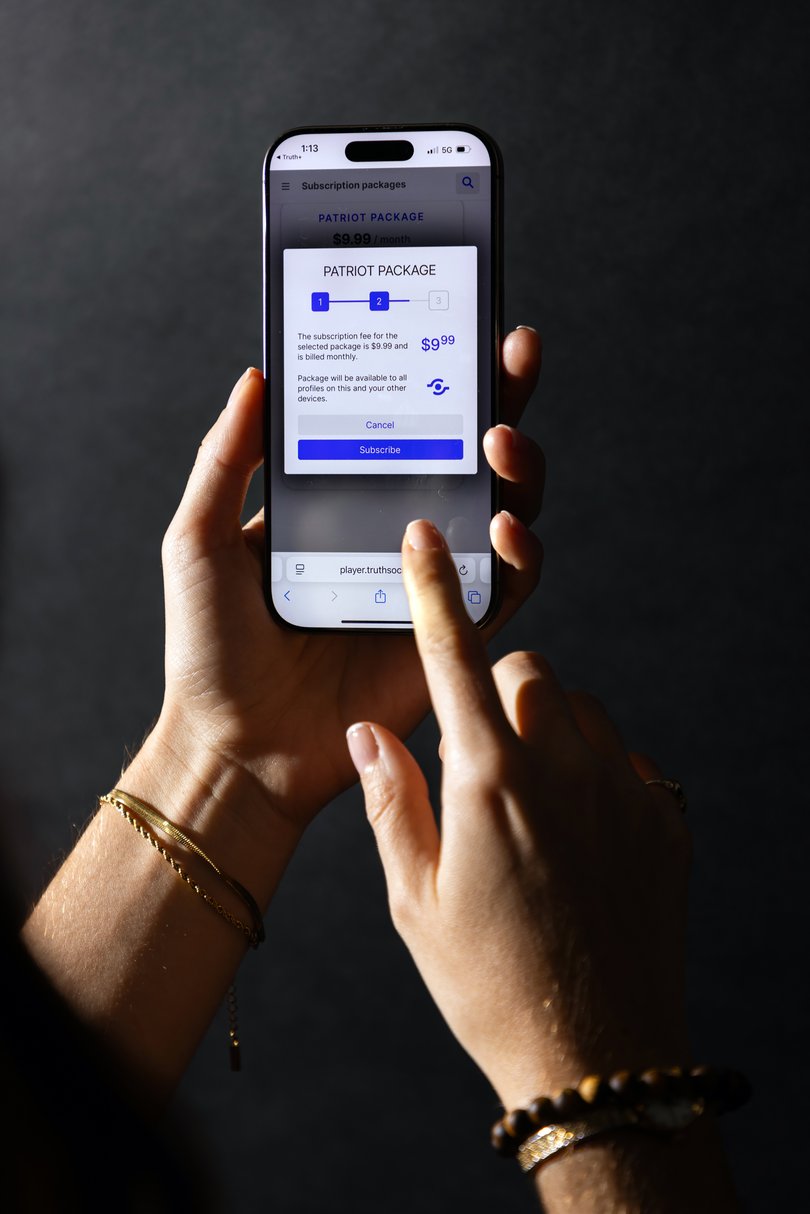 An iPhone user looks at the Patriot Package subscription tier on the Truth+ app, a video-on-demand service from Trump Media.