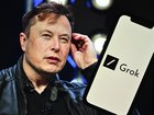 Elon Musk's photo is displayed in front of Grok logo on a phone screen.