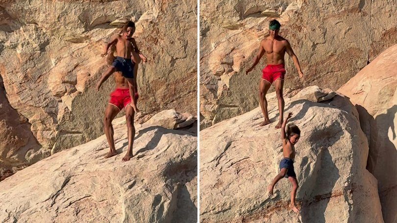 Garrett Gee throws his son Calihan off a cliff in Lake Powell.
