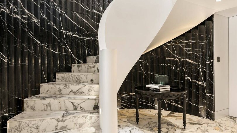 A dramatic curved staircase leads to the upper floors.