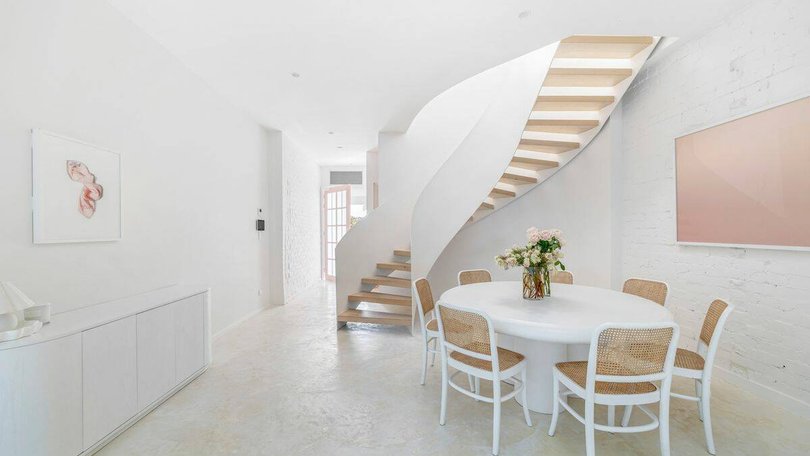 The standout staircase fits with the contemporary coastal look of the home.