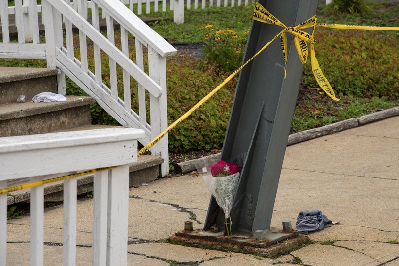 Flowers left outside of fire line tape at the fire-damaged Gabriel House, an assisted living facility, in Fall River, Mass., on Monday, July 14, 2025. Nine people were killed and one person was in critical condition after a large fire broke out at the assisted living facility on Sunday night, officials said. (Philip Keith/The New York Times)