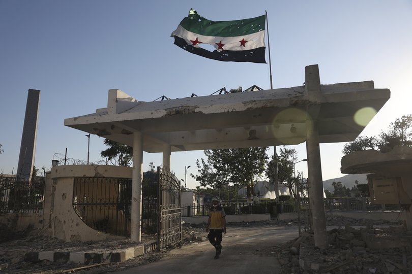 A civil defence worker enters the Syrian Defence Ministry building after an Israeli airstrike in Damascus, Syria.