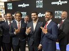 Investment banker Omeed Malik (2-L), Marc Nemati, CEO of GrabAGun (4-L), and Donald Trump Jr. (2-R) pose while holding their hands in the shape of guns at the New York Stock Exchange.