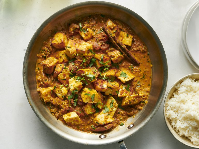 A tomato curry with crispy and creamy paneer from chef Anita Jaisinghani. Chunks of the cheese are roasted while a warmly spiced curry simmers away on the stove. Food Stylist: Simon Andrews. (David Malosh/The New York Times)