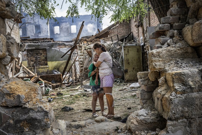 Natalia Harbuznia comforts her daughter Victoria after Russian drones struck a neighborhood in Odesa, Ukraine.