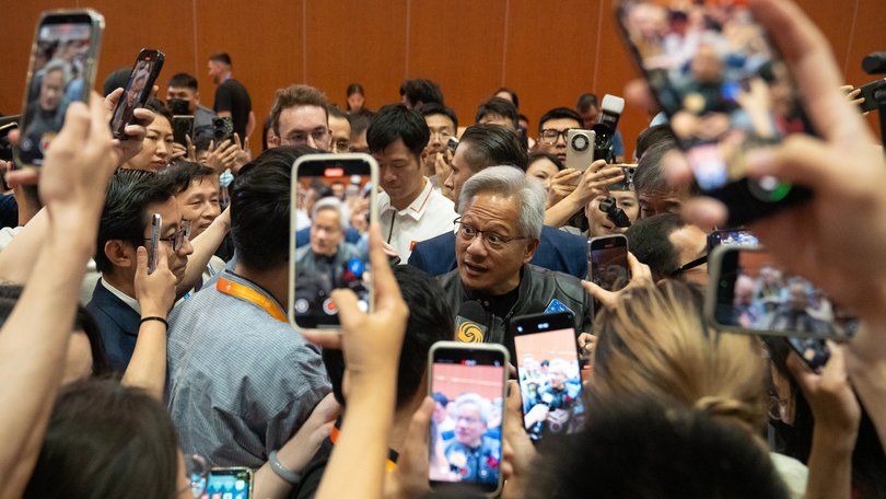 Jensen Huang is mobbed during the China International Supply Chain Expo in Beijing  on Thursday, July 17, 2025. 