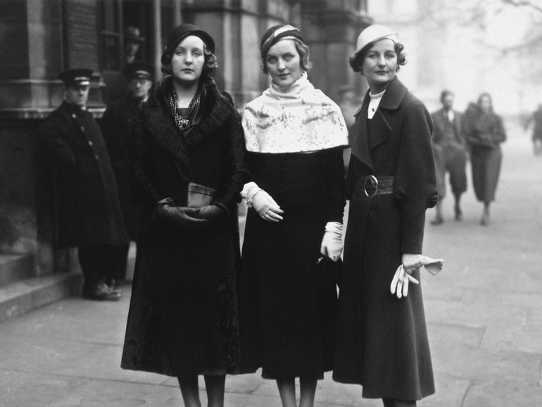 1932:  Three of the Mitford sisters at Lord Stanley of Aldernay's wedding.  From left to right: Unity Mitford; Diana Mitford (Mrs Bryan Guinness, later Lady Diana Mosley) and writer Nancy Mitford.  (Photo by Hulton Archive/Getty Images)