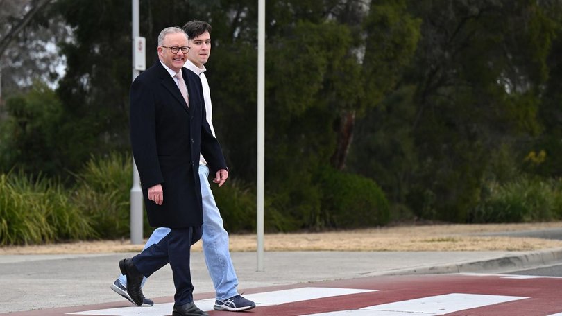 Anthony Albanese was all smiles on his morning commute to Parliament House with son Nathan. (Lukas Coch/AAP PHOTOS)