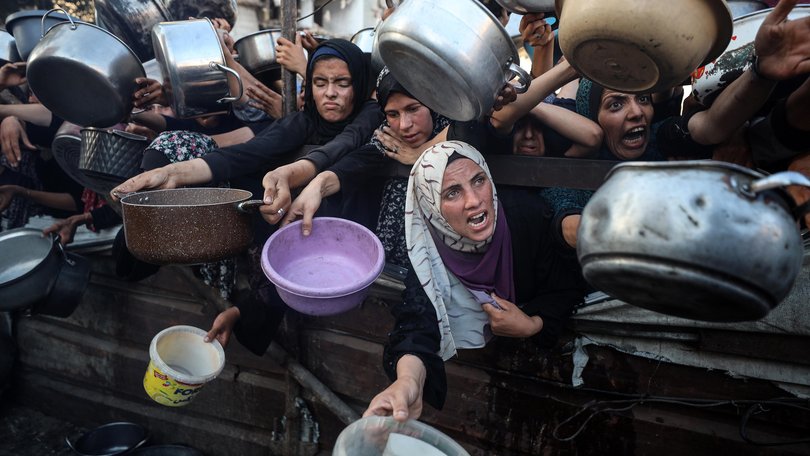 Palestinians gather at a food distribution point in Gaza City, on July 20.
