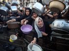 Palestinians gather at a food distribution point in Gaza City, on July 20.