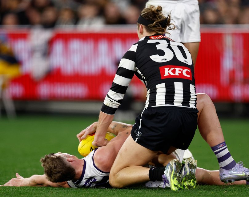 Collingwood defender Darcy Moore has avoided a sanction for dropping his knees into Josh Treacy on Sunday.