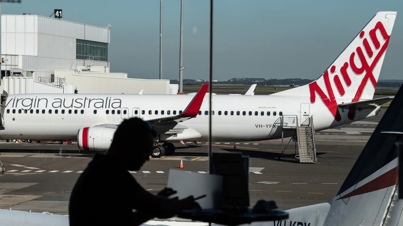 Virgin Australia has not confirmed the cause of a fire that broke out in a plane's overhead locker.