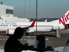 Virgin Australia has not confirmed the cause of a fire that broke out in a plane's overhead locker.
