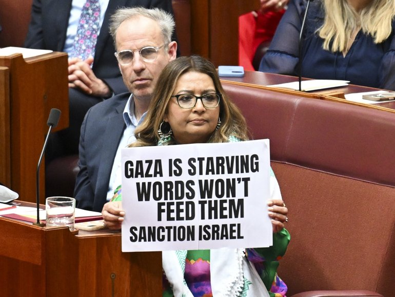 Senator Mehreen Faruqi holds up a pro Palestine sign during Governor-General Sam Mostyn’s address to the Senate.