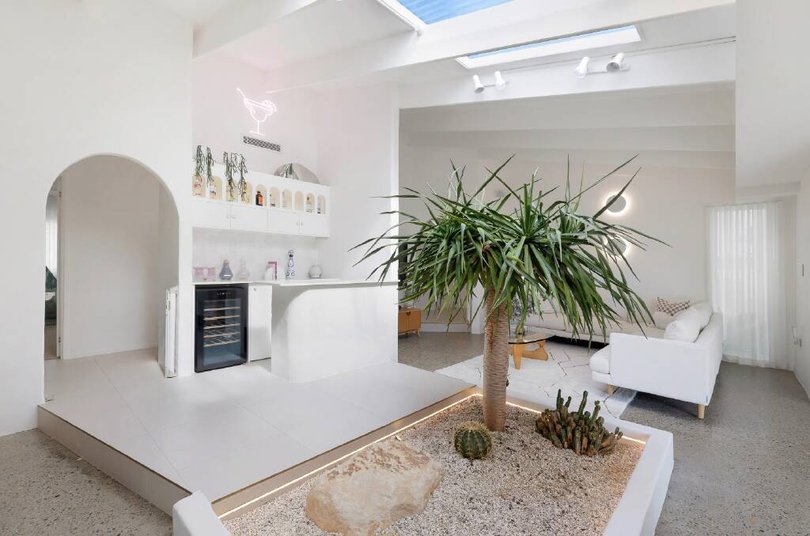 The living room features an internal garden and a built-in bar.