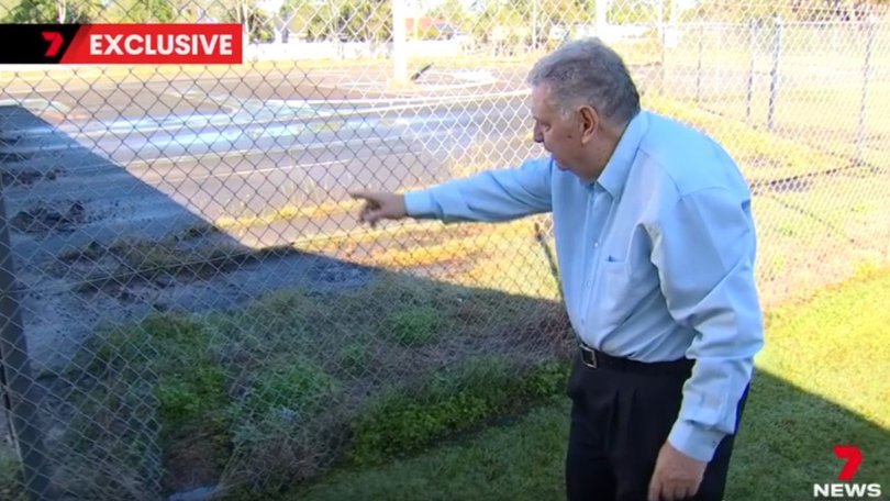 Club treasurer Les Marsh points to hair found tangled in a fence, a potential clue police are now examining.