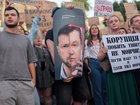 A protester in Kyiv holds a poster likening Ukraine’s President Volodymyr Zelensky to former president Viktor Yanukovych, who was ousted after the 2014 protests called the Revolution of Dignity.