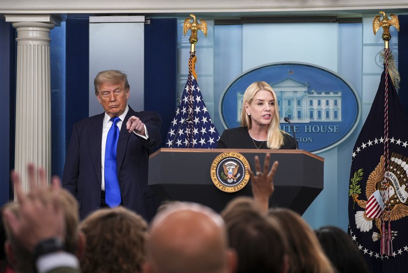 United States Attorney General Pamela Bondi speaks as President Donald Trump points to take a question in the White House press briefing room.
