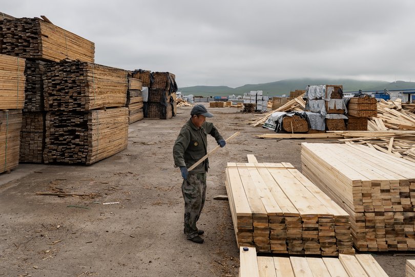 A worker at a lumber yard in the border town of Manzhouli.
