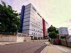 A trainee surgeon has been refused bail after he was charged with filming hundreds of staff through a concealed camera in a hospital toilet.