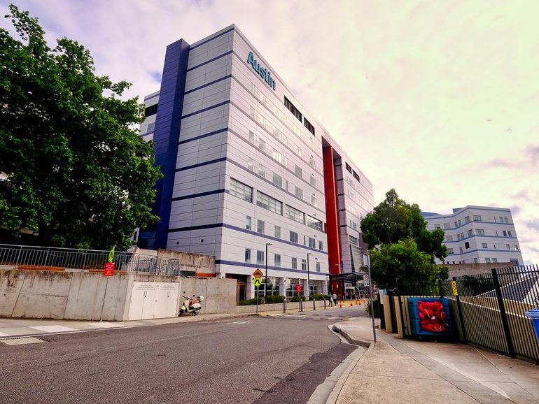 A trainee surgeon has been refused bail after he was charged with filming hundreds of staff through a concealed camera in a hospital toilet.