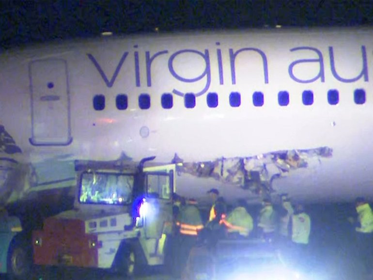 A Virgin plane has been badly damaged on the tarmac of Melbourne airport after colliding with a towing vehicle.