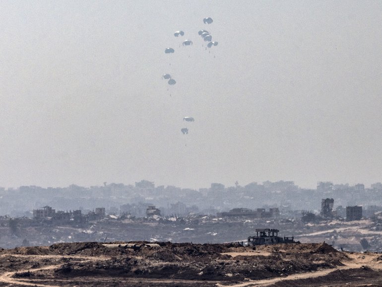 Humanitarian aid is airdropped over Gaza City on Sunday. Israel allowed Jordan and the United Arab Emirates to parachute aid into the enclave. 