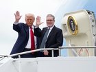 US President Donald Trump and British Prime Minister Keir Starmer wave as they board Air Force One at Prestwick Airport.