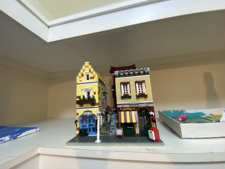 Artworks and figurines were seen on the shelves in the walk-in-wardrobe of the main bedroom. Pictured is a completed Lego set of a streetscape. 
