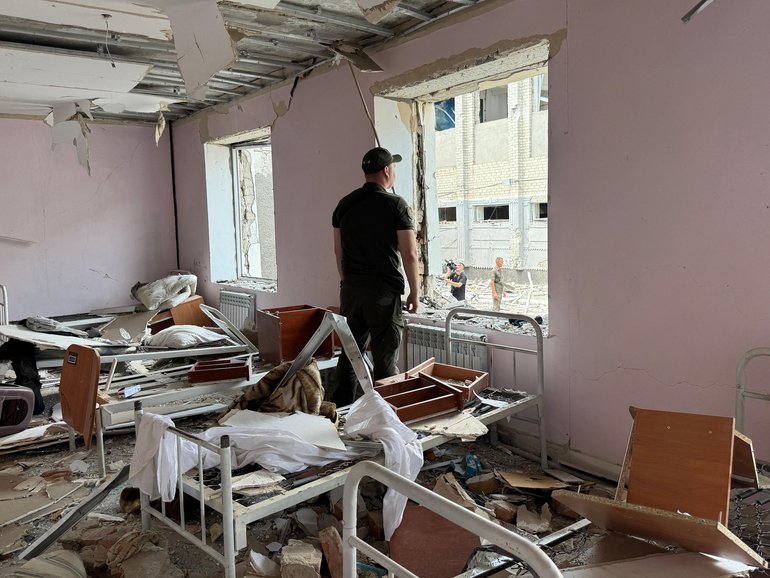 A Ukrainian law enforcement officer inside a destroyed building in a correctional colony hit in a Russian air attack in Bilenke, Zaporizhzhia.