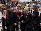 The family of Ozzy Osbourne: Jack, Sharon and Kelly Osbourne, view the messages and floral tributes left at the Black Sabbath Bridge bench.