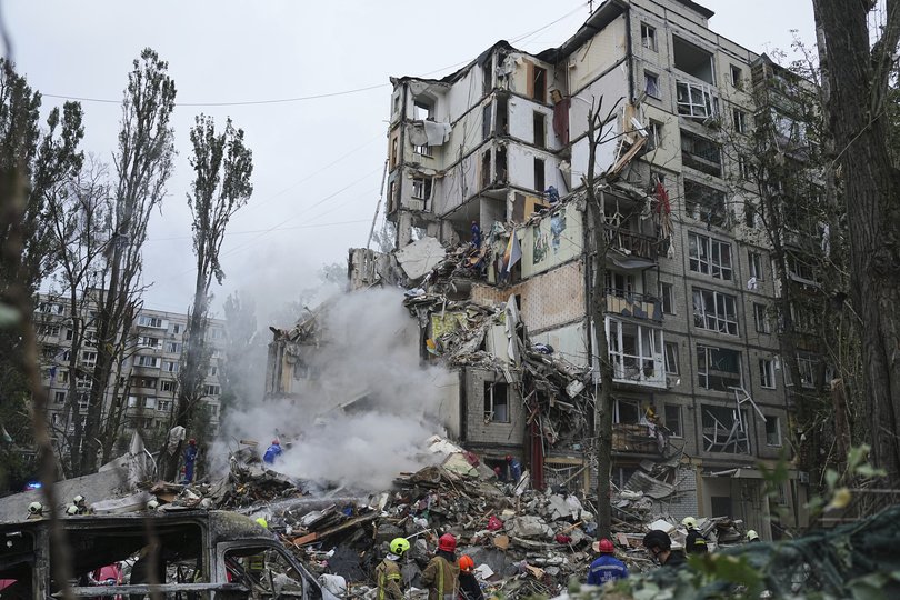 Rescuers work in a destroyed apartment building after a Russian missile attack in Kyiv, Ukraine, Thursday, July 31, 2025.